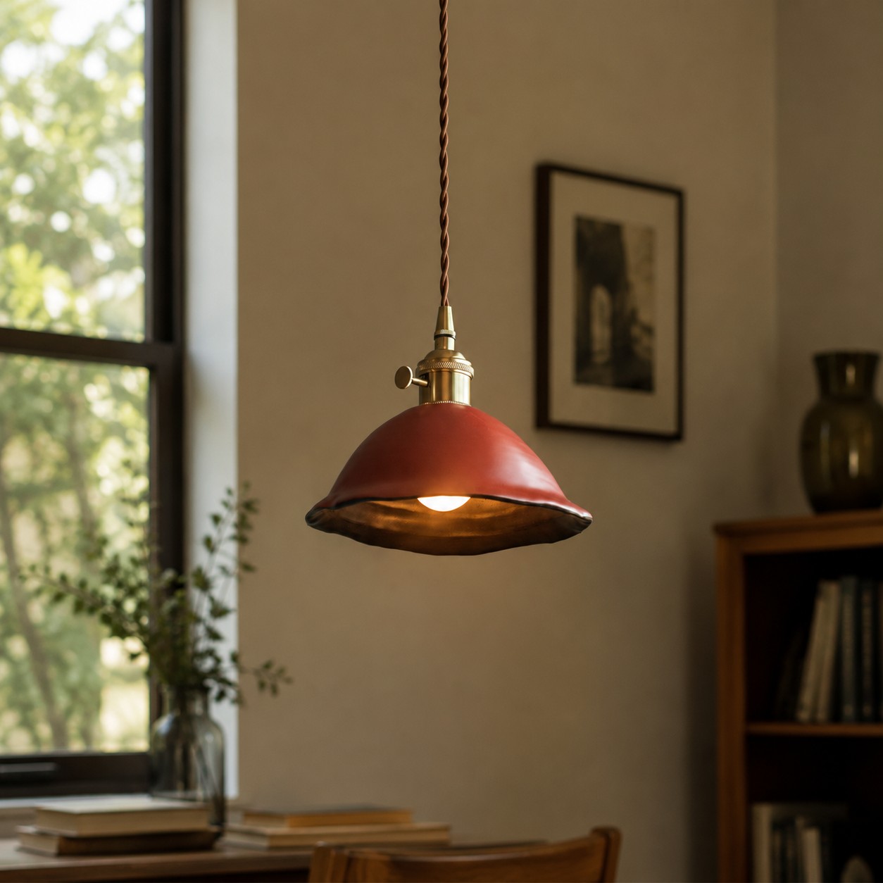 Close view of the brass-toned pendant fitting and cord