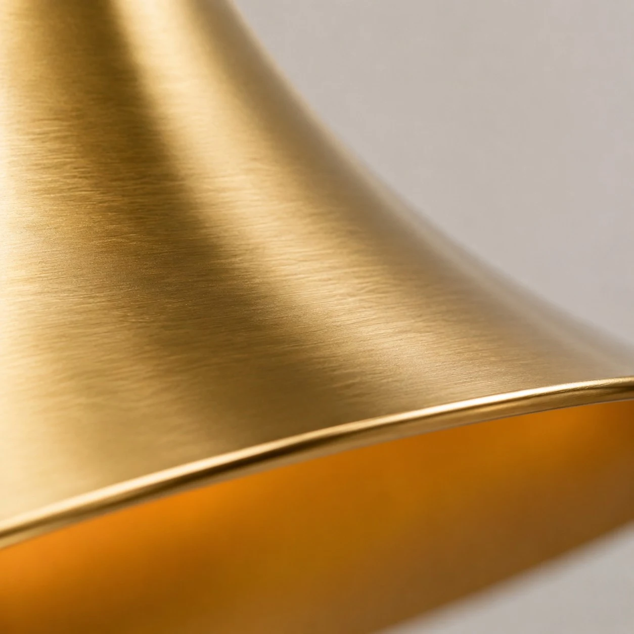 Brushed brass surface and rolled shade edge