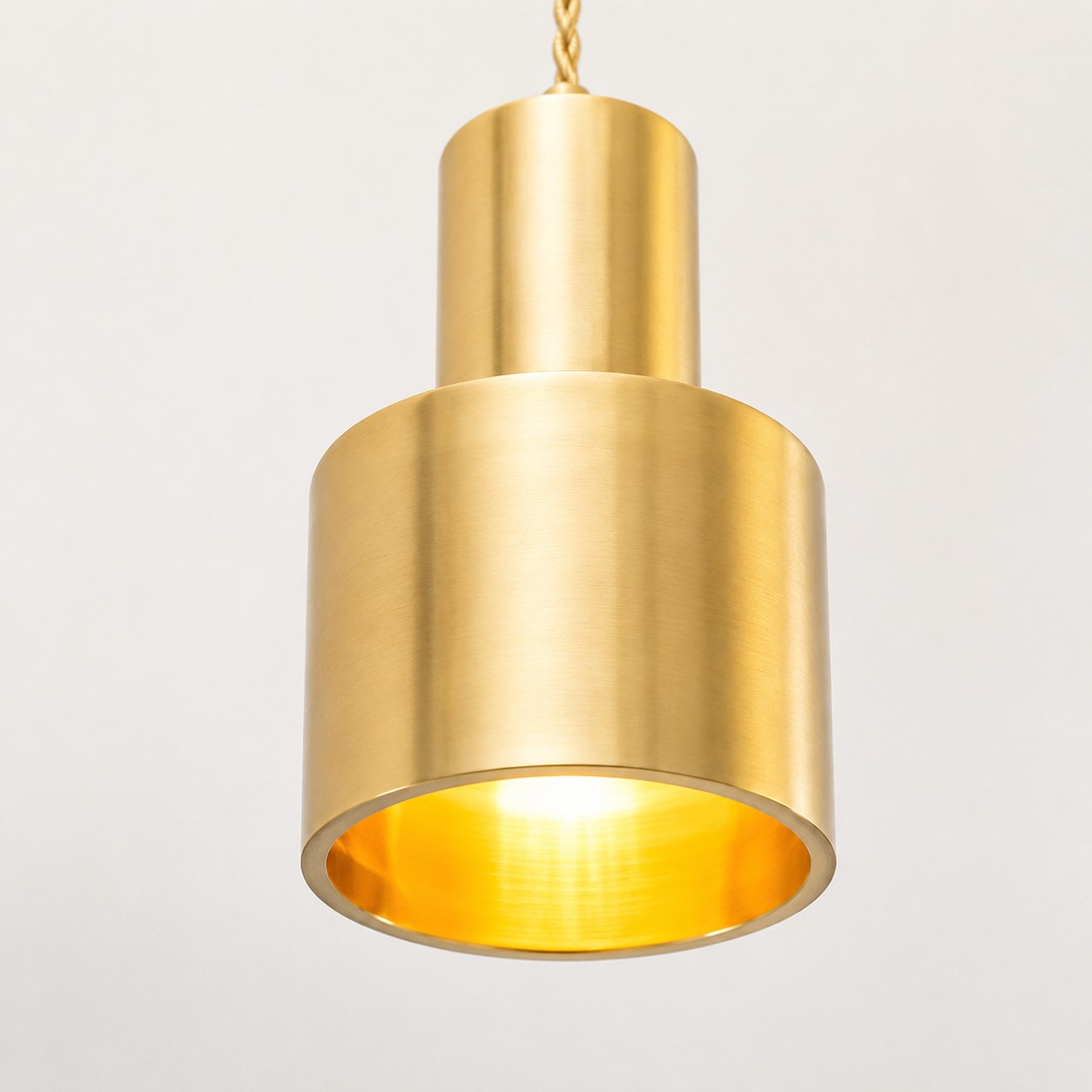 Warm brass shade: The cylindrical shade keeps the light focused while showing a clean brushed brass surface.