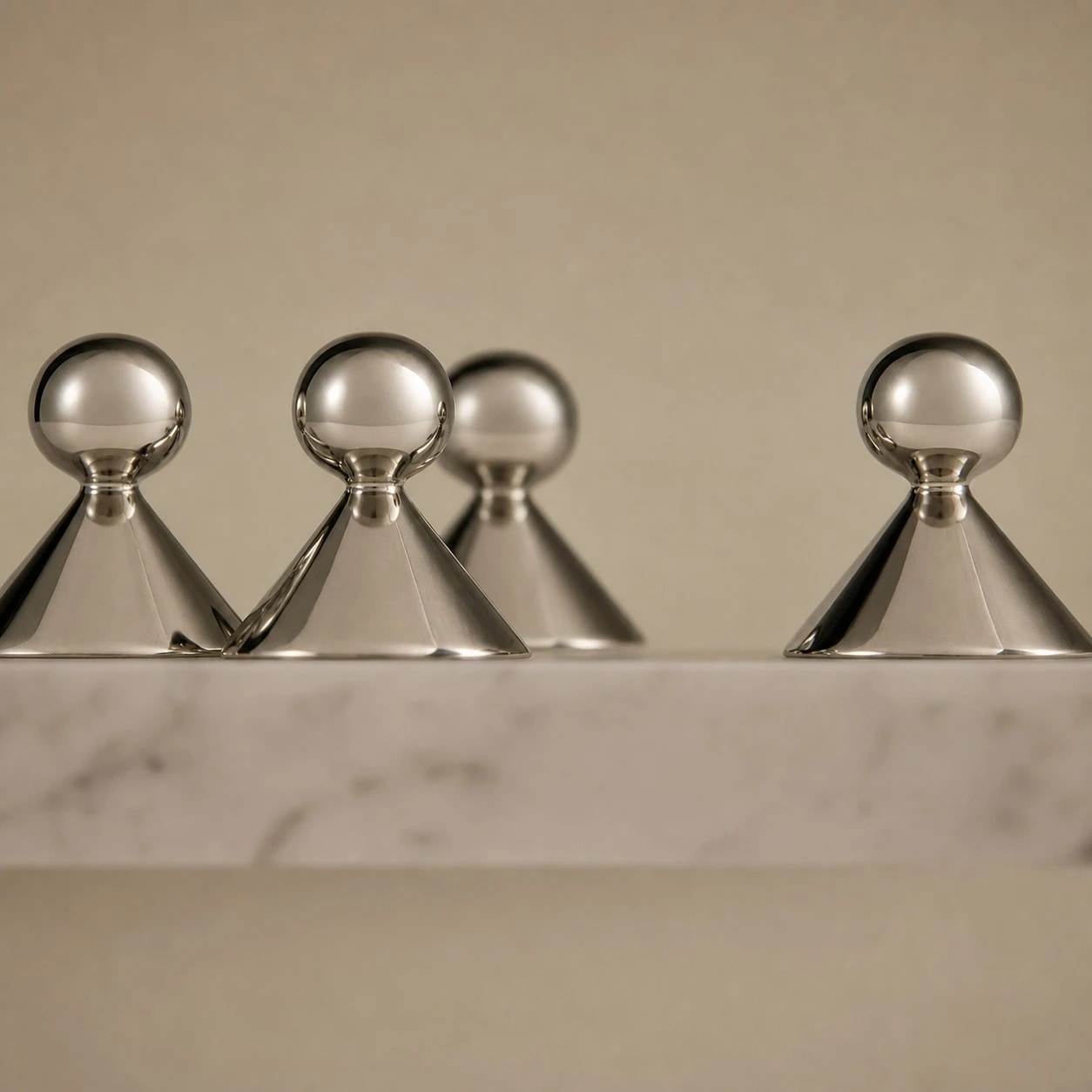 Sculptural brass cabinet knobs shown from several angles
