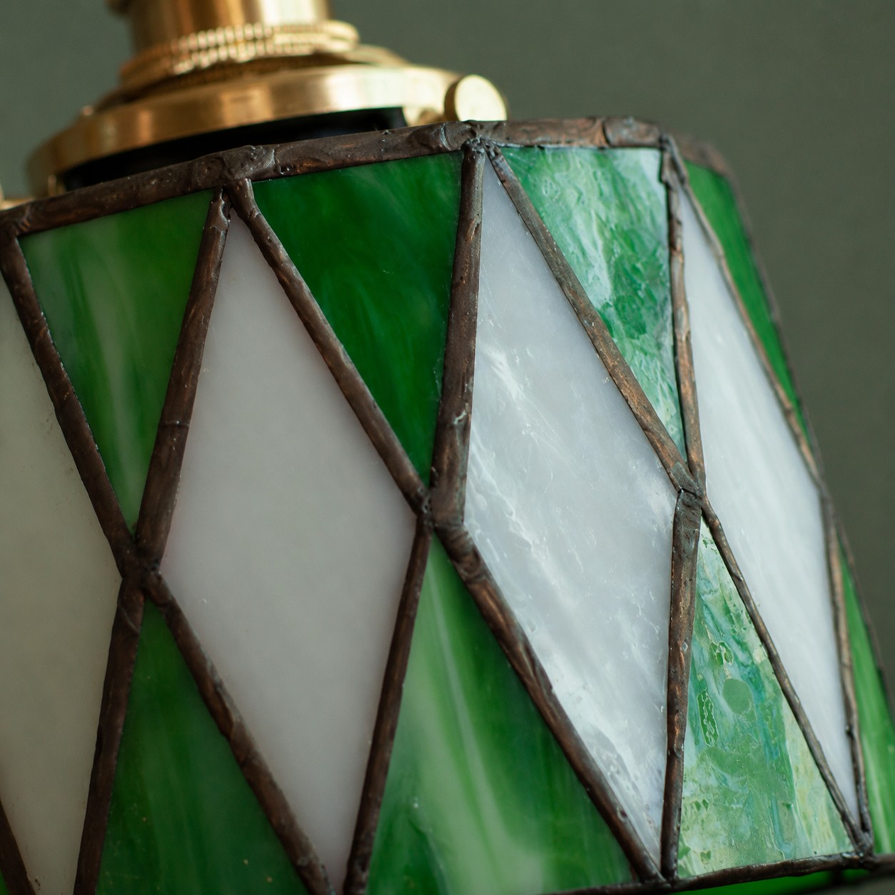 Green stained-glass pendant light on white background