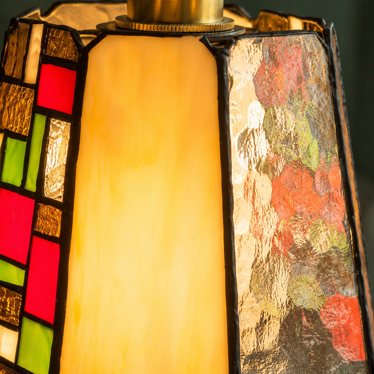 Close view of the textured glass and copper-tone lamp holder