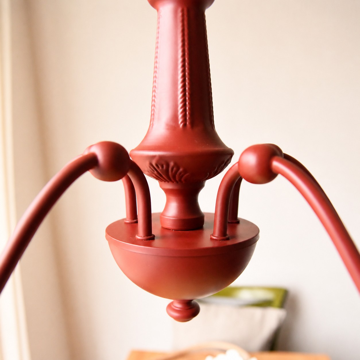 Turned center column and iron arm junction in vermilion red
