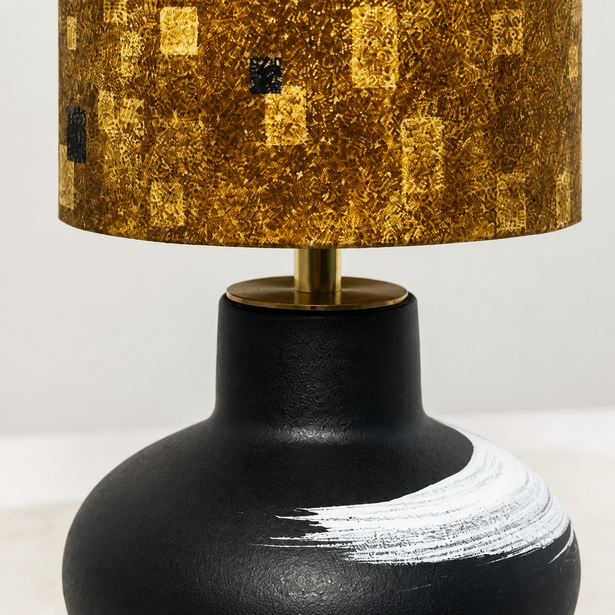 Vue rapprochée du corps de la lampe en céramique et de la tige aux tons laiton