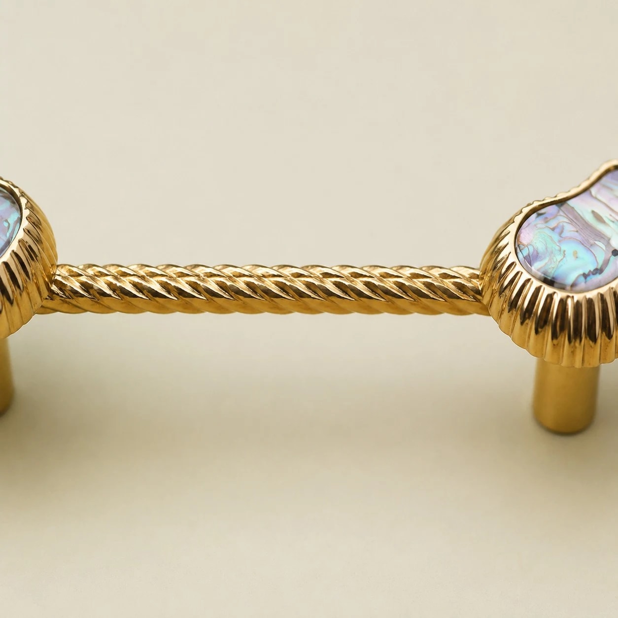 Twisted brass bar detail on cashew shell cabinet pull