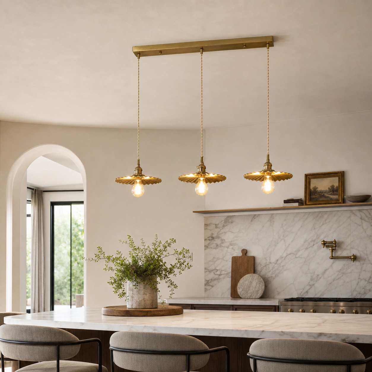 Three-light brass pendant over a kitchen island