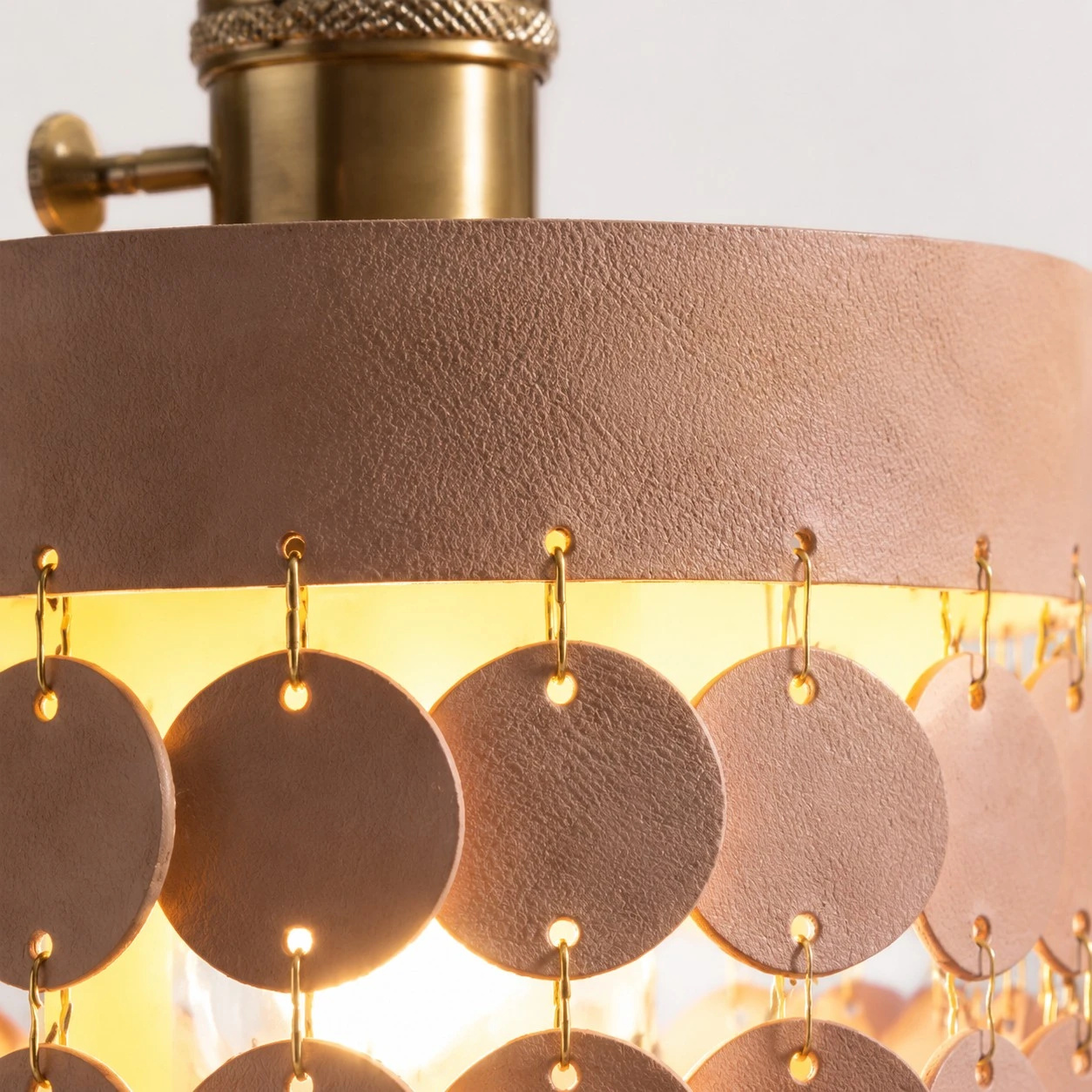 Close view of textured leather discs and metal links