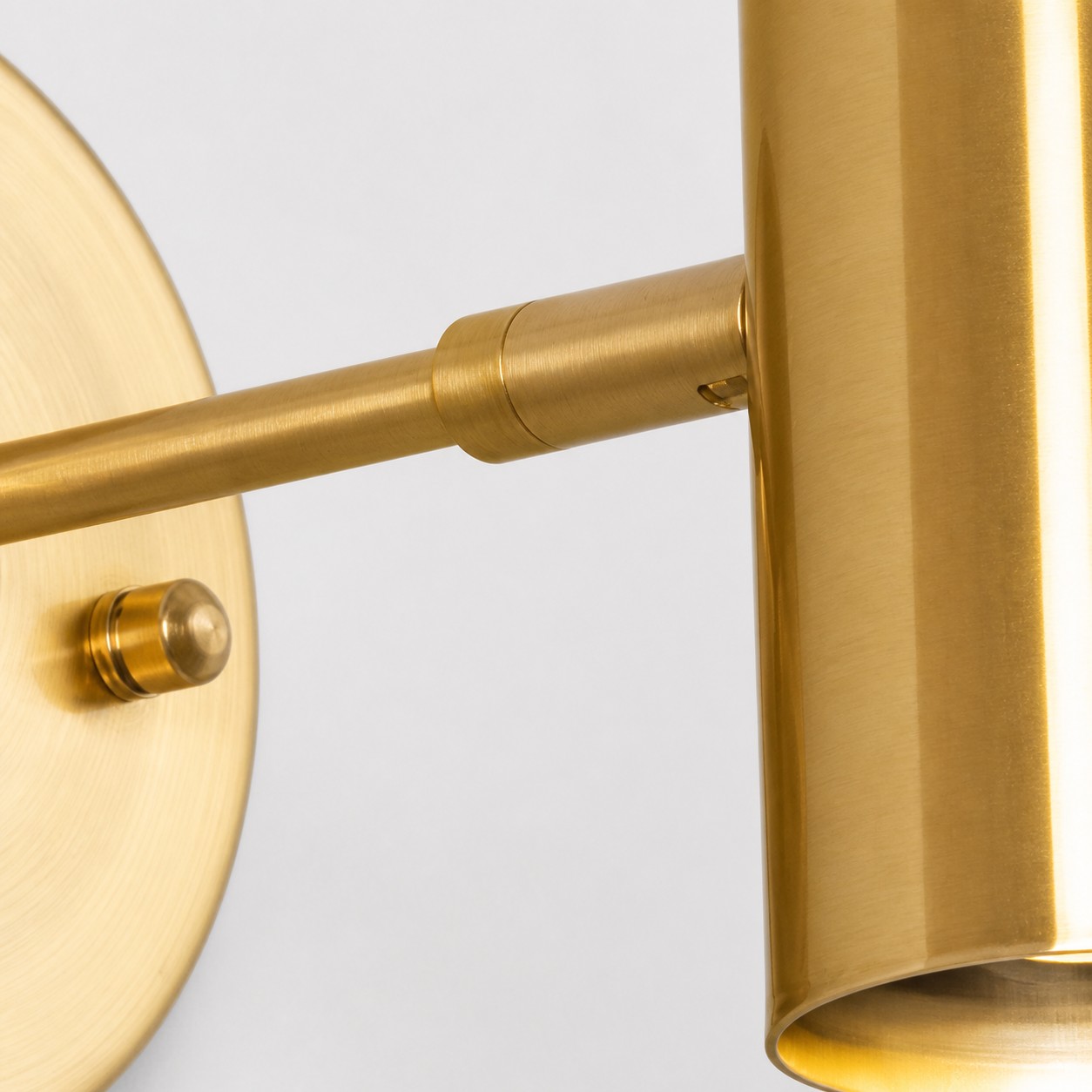 Brushed brass arm connection and cylinder detail