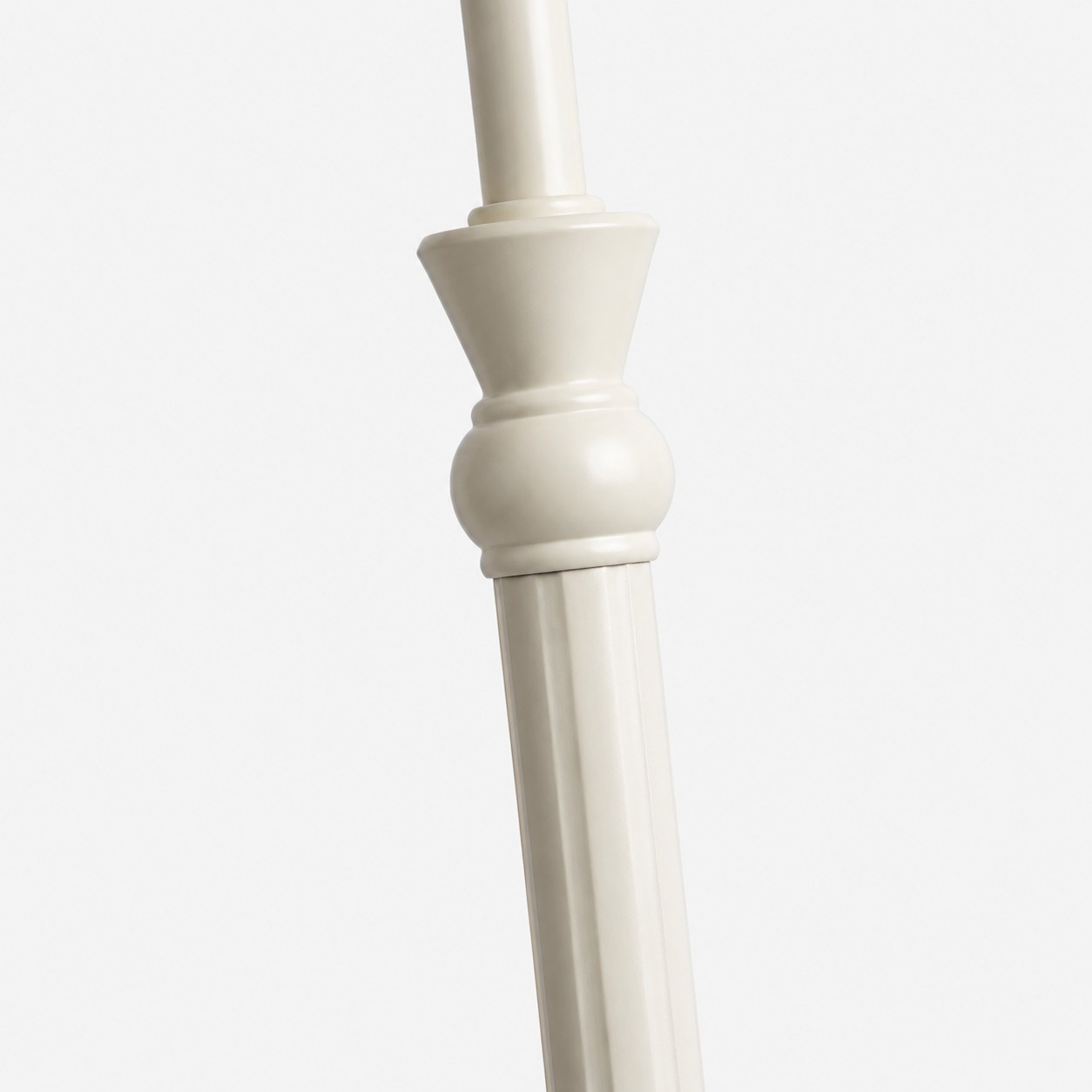 Close-up of turned decorative details on the ivory metal lamp stem