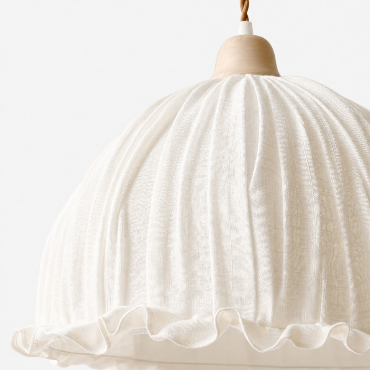 Ivory fabric pleats and ruffled edge detail
