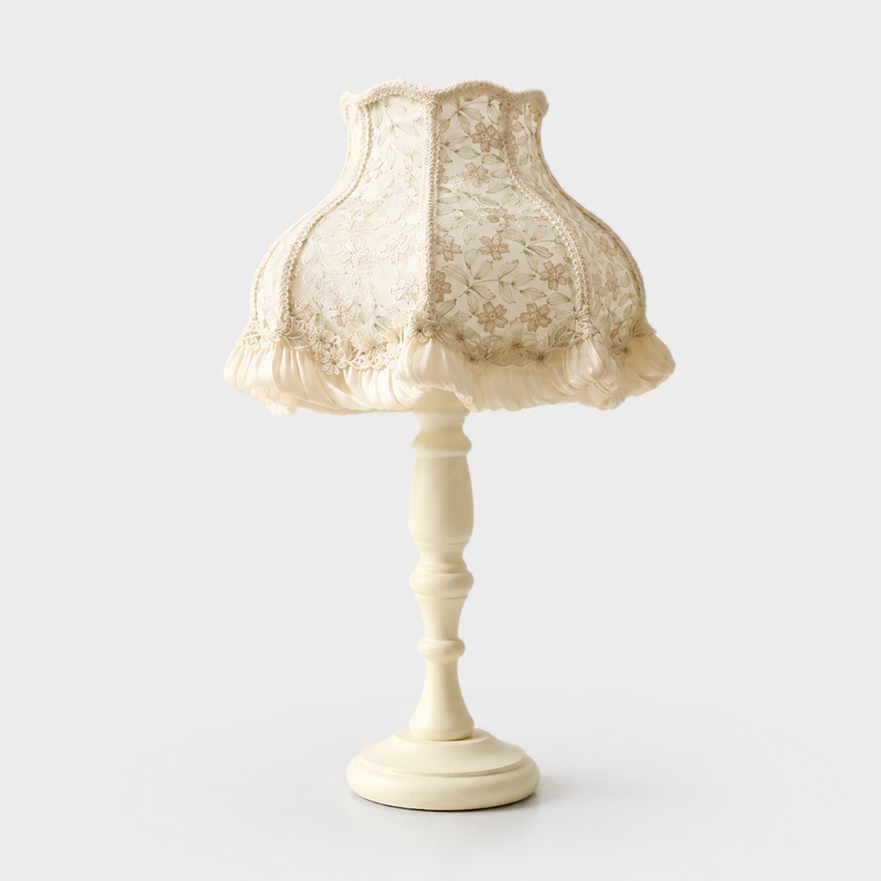 Pearl lace fabric table lamp on a light background