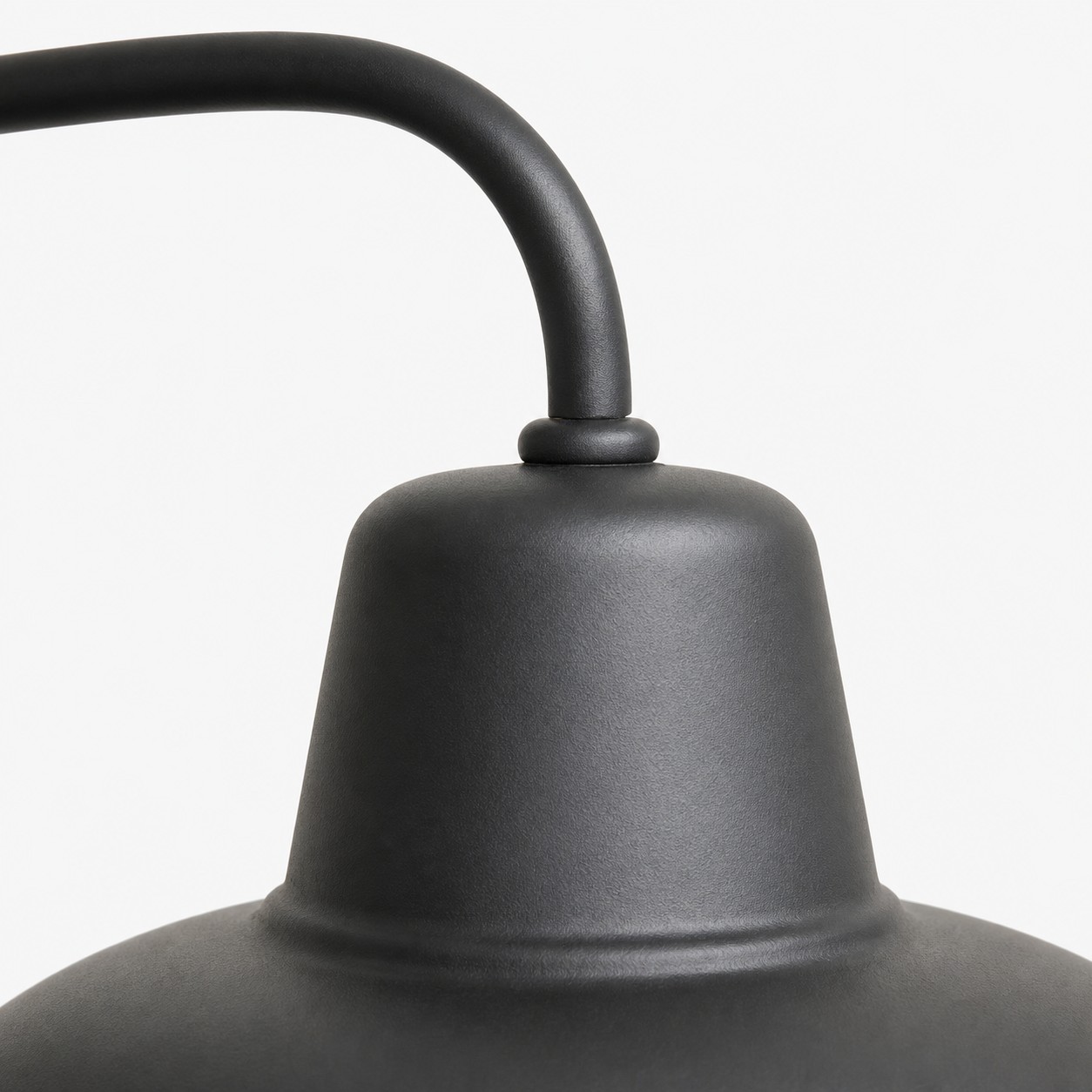 Curved arm detail on vintage metal outdoor wall sconce