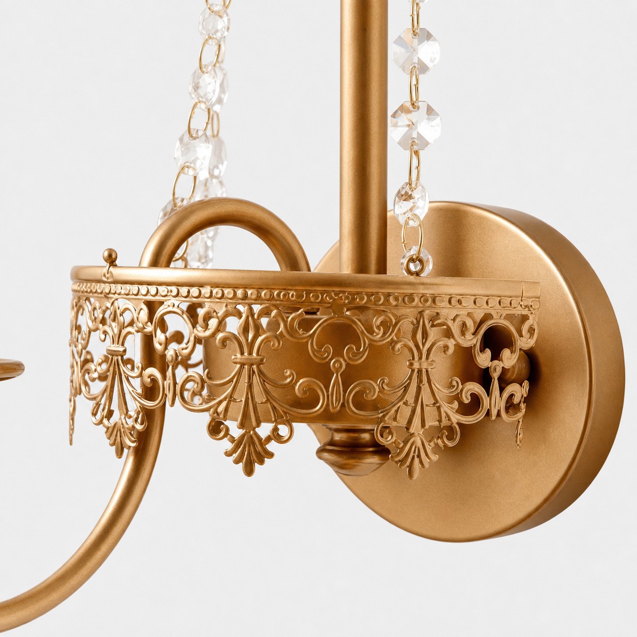 Close view of the pierced metal trim crystal strands and round wall plate