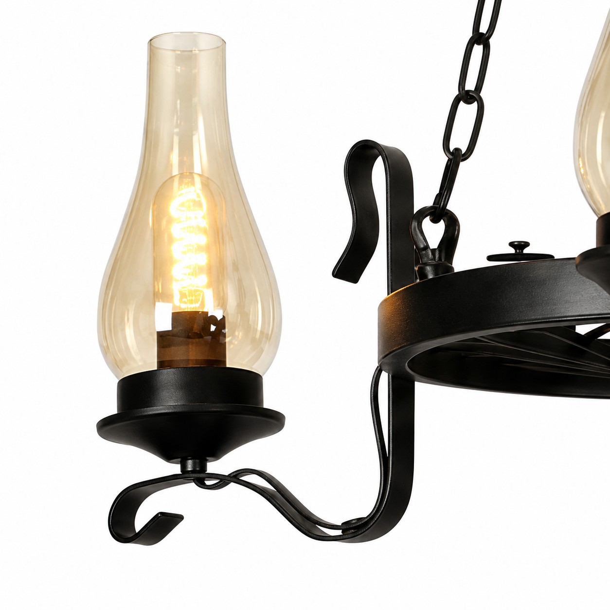 Close-up of clear hurricane glass shade and curved black iron arm