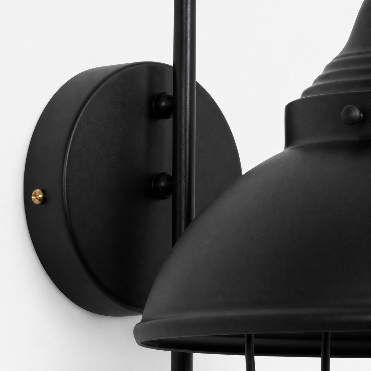 Round black wall plate and metal connection detail