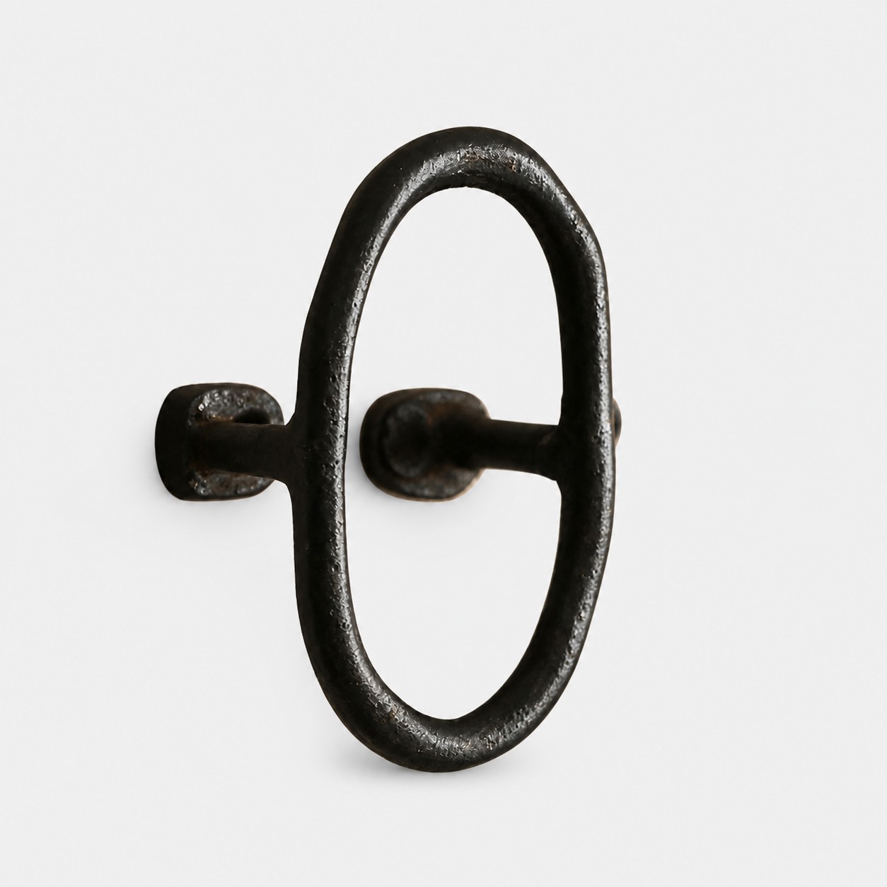 black iron ring wall hook on grey background