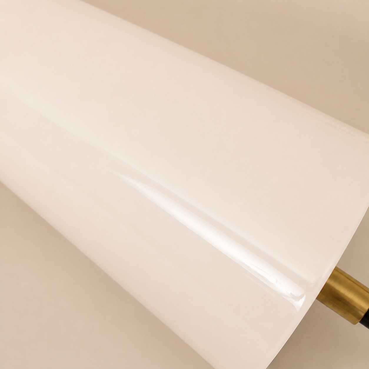 close view of white glass shade and copper detail