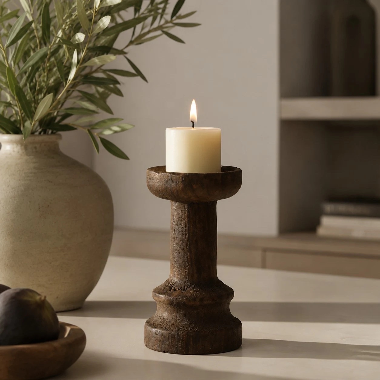 Solid wood candle holder in a calm sunlit tabletop setting; candle not included