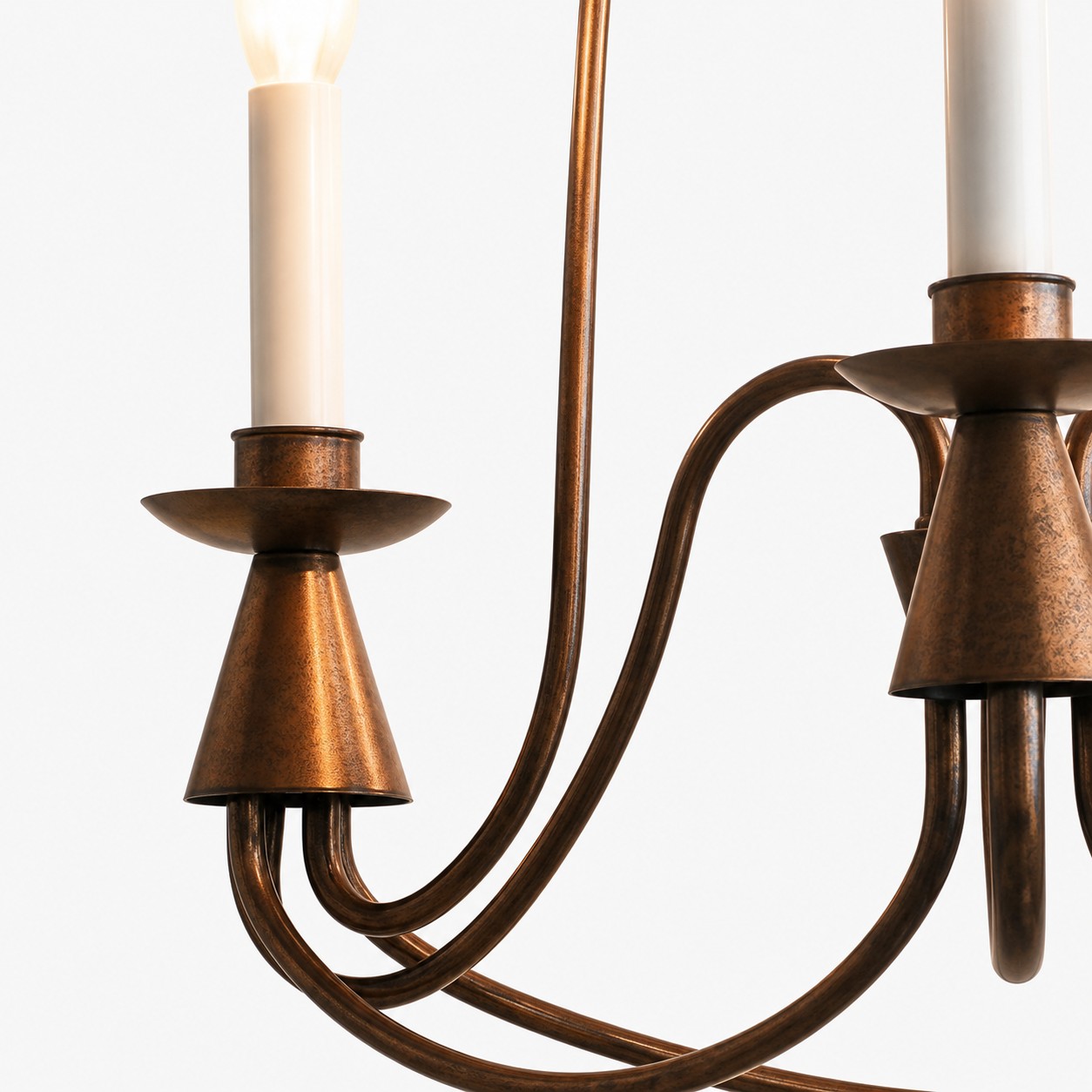 Close-up of antique bronze candle cup and curved iron arms