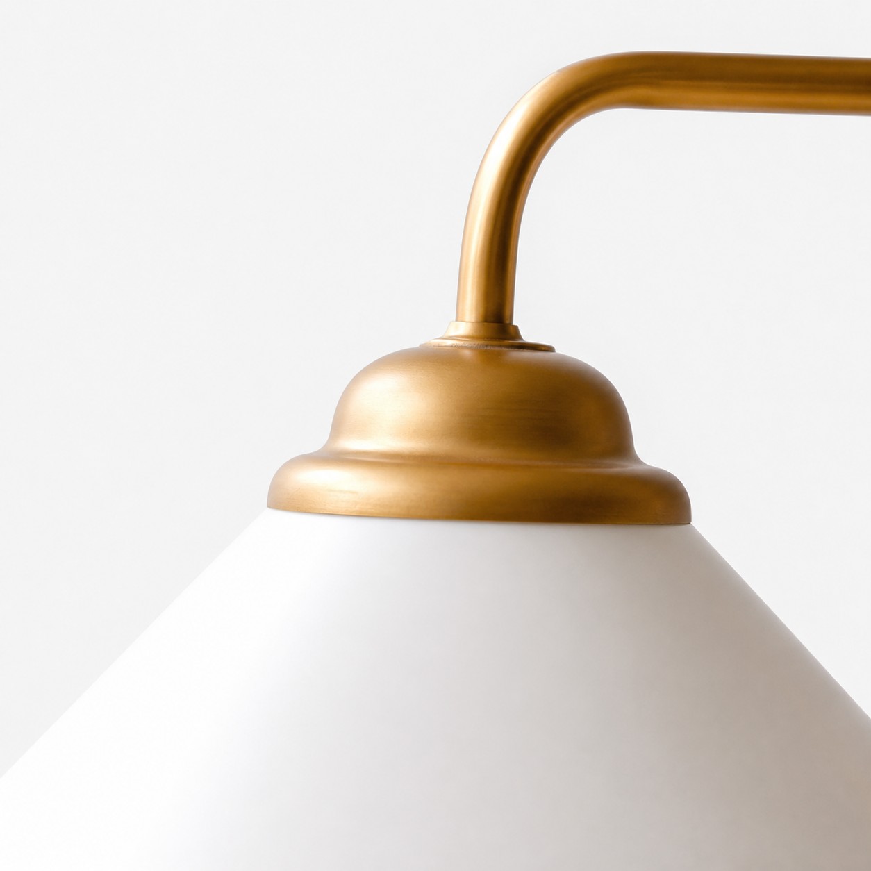 Curved arm and milk-white glass shade connection detail