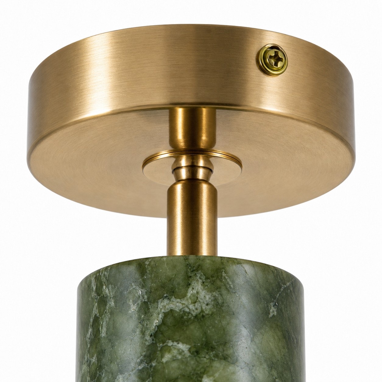 Brass-tone ceiling canopy and jade shade connection detail
