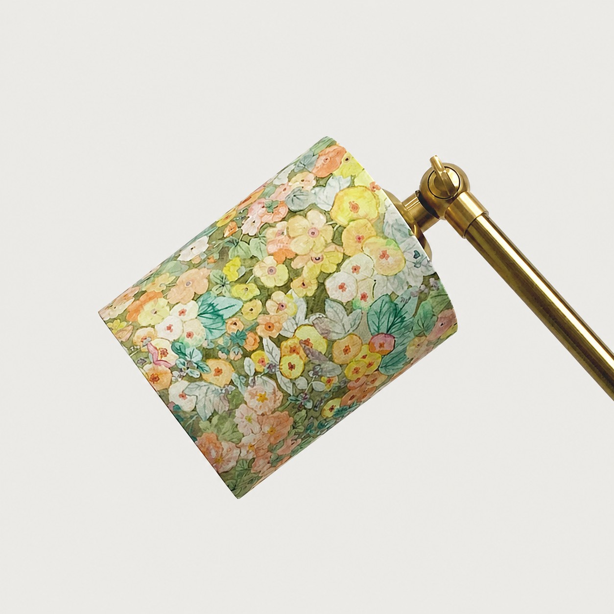Floral fabric shade and brass arm detail