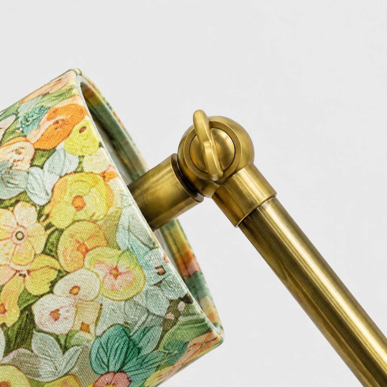 Adjustable joint and floral fabric shade close-up