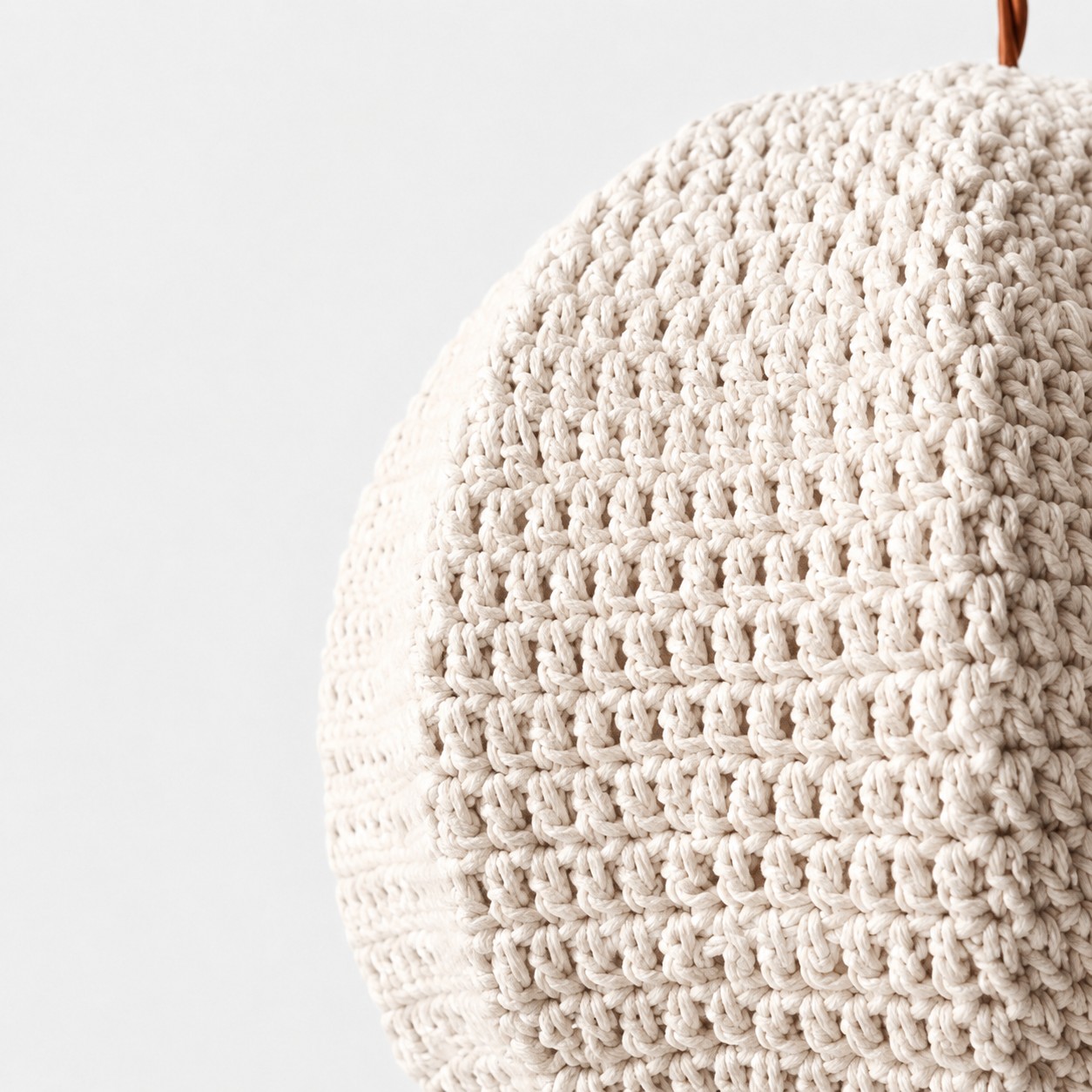 Dense and open stitch patterns across the ivory woven shade