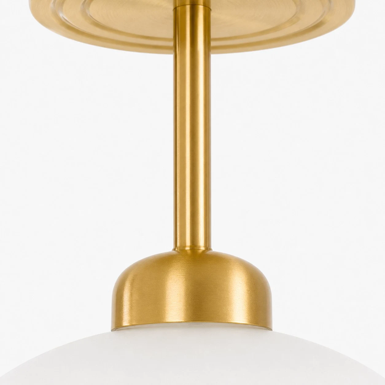 Close view of the brass-toned stem and glass connection