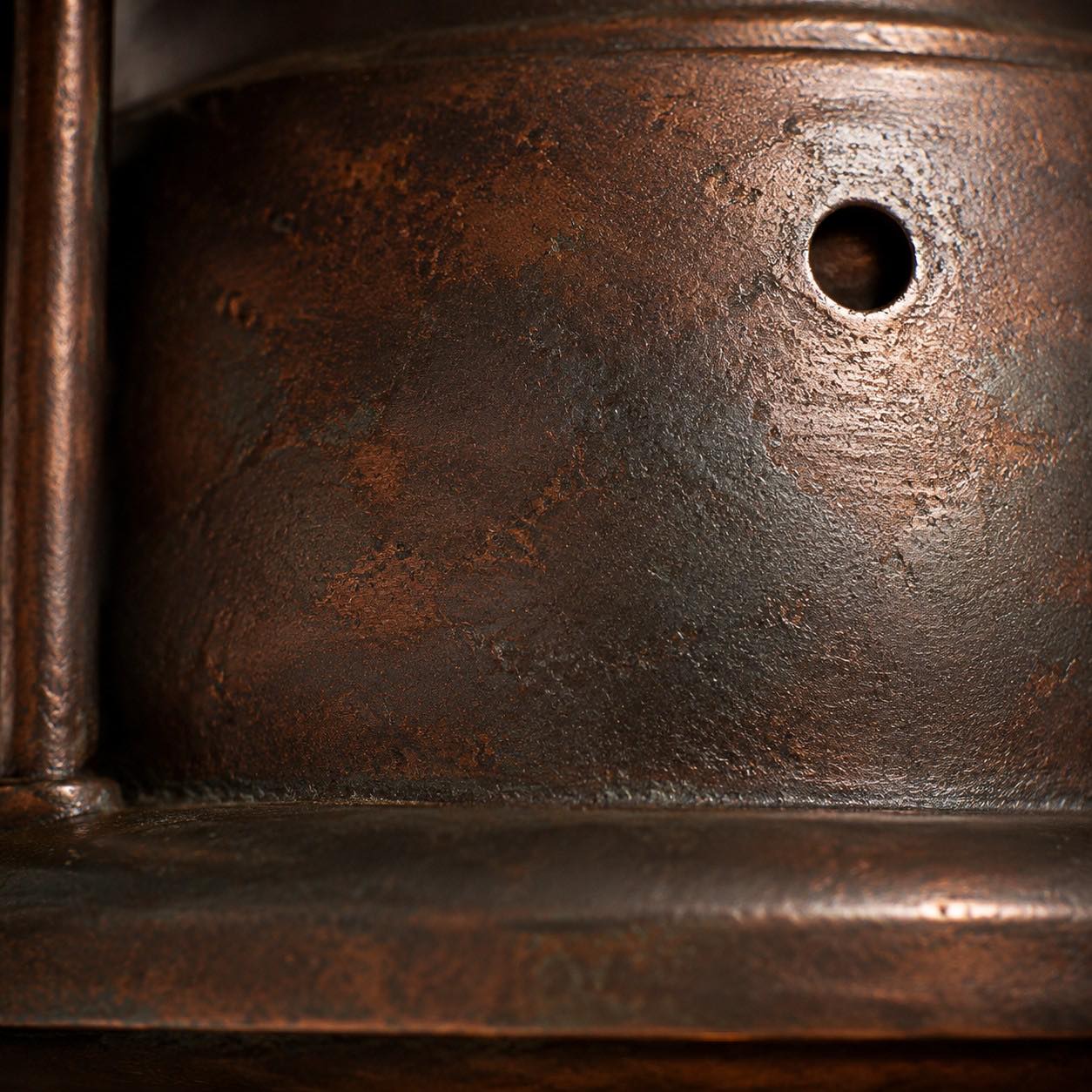 close view of riveted iron shade and protective cage