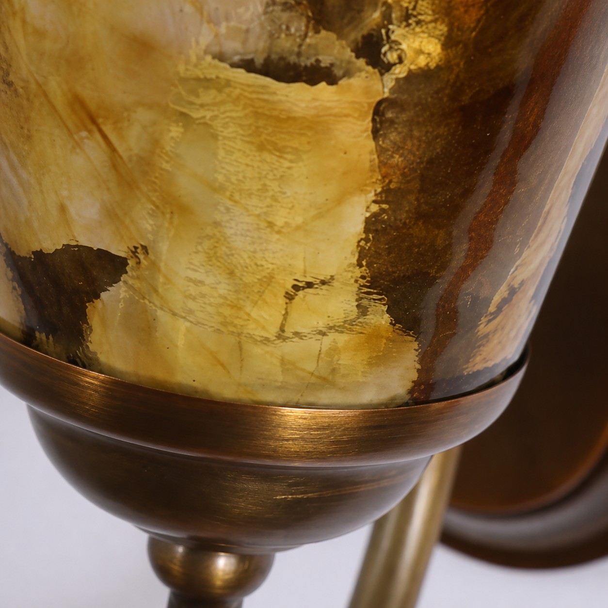 Amber glass shade held by an antique brass cup