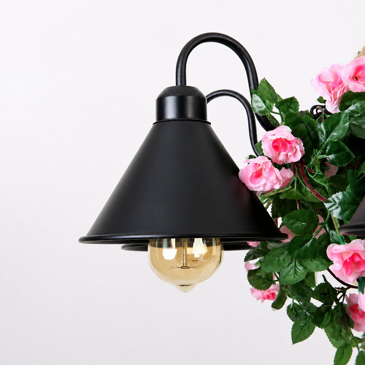 Pink flower accent beside the black shade
