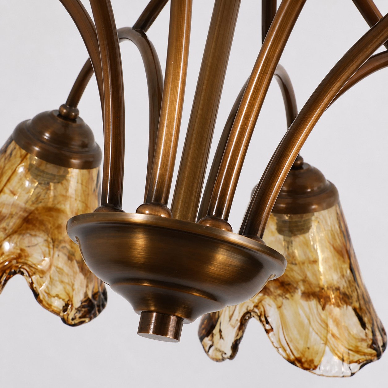 Curved brass chandelier arms and central fitting