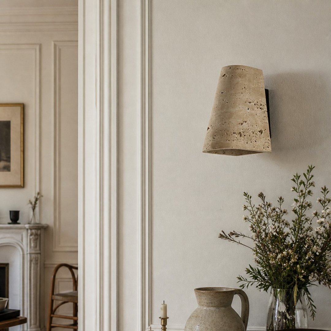 Travertine wall sconce installed in a refined dining interior