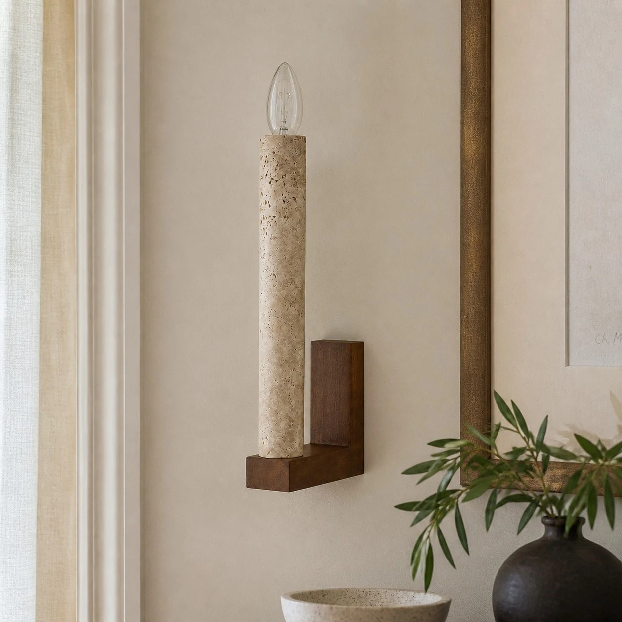 Natural travertine wall sconce in a warm layered interior
