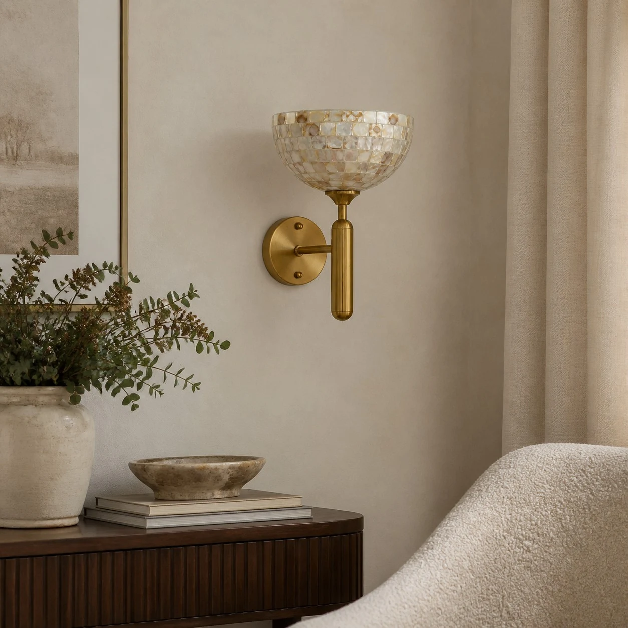 White shell and brass wall sconce in a calm layered bedroom