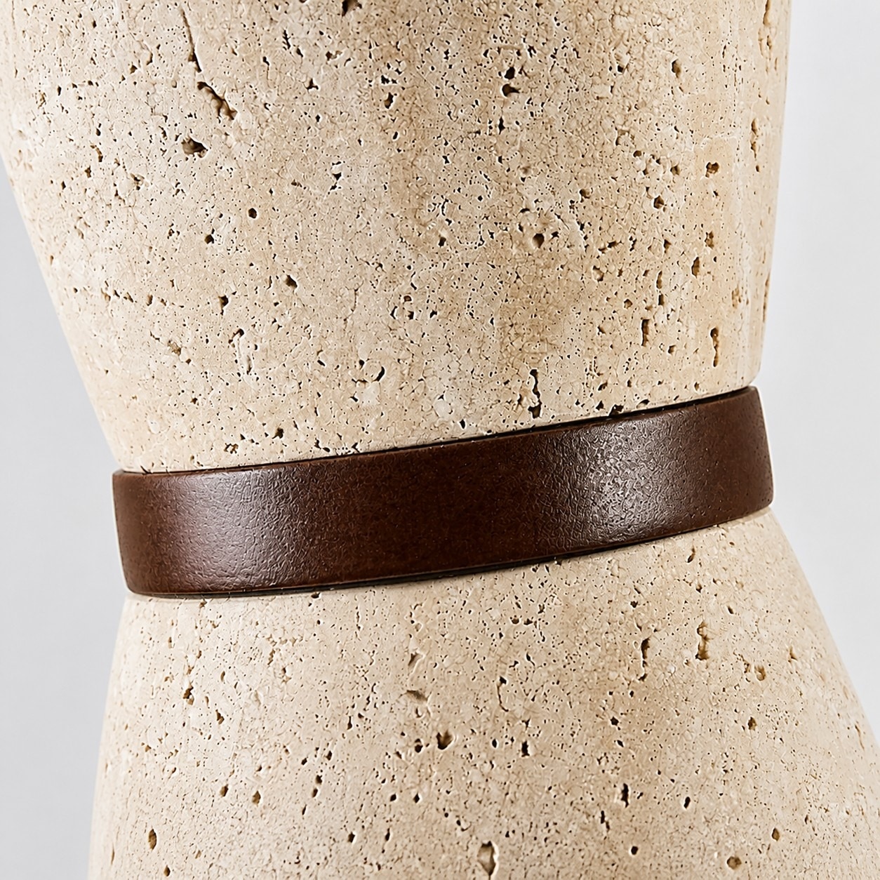 Close view of natural travertine texture and solid wood band