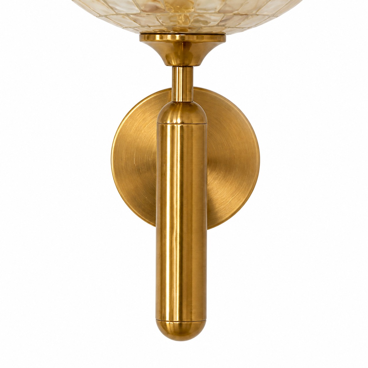 Close view of the shell shade and brushed brass connection
