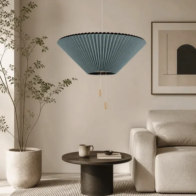 Adjustable pleated pendant light beside a living room side table with on and off lighting effect