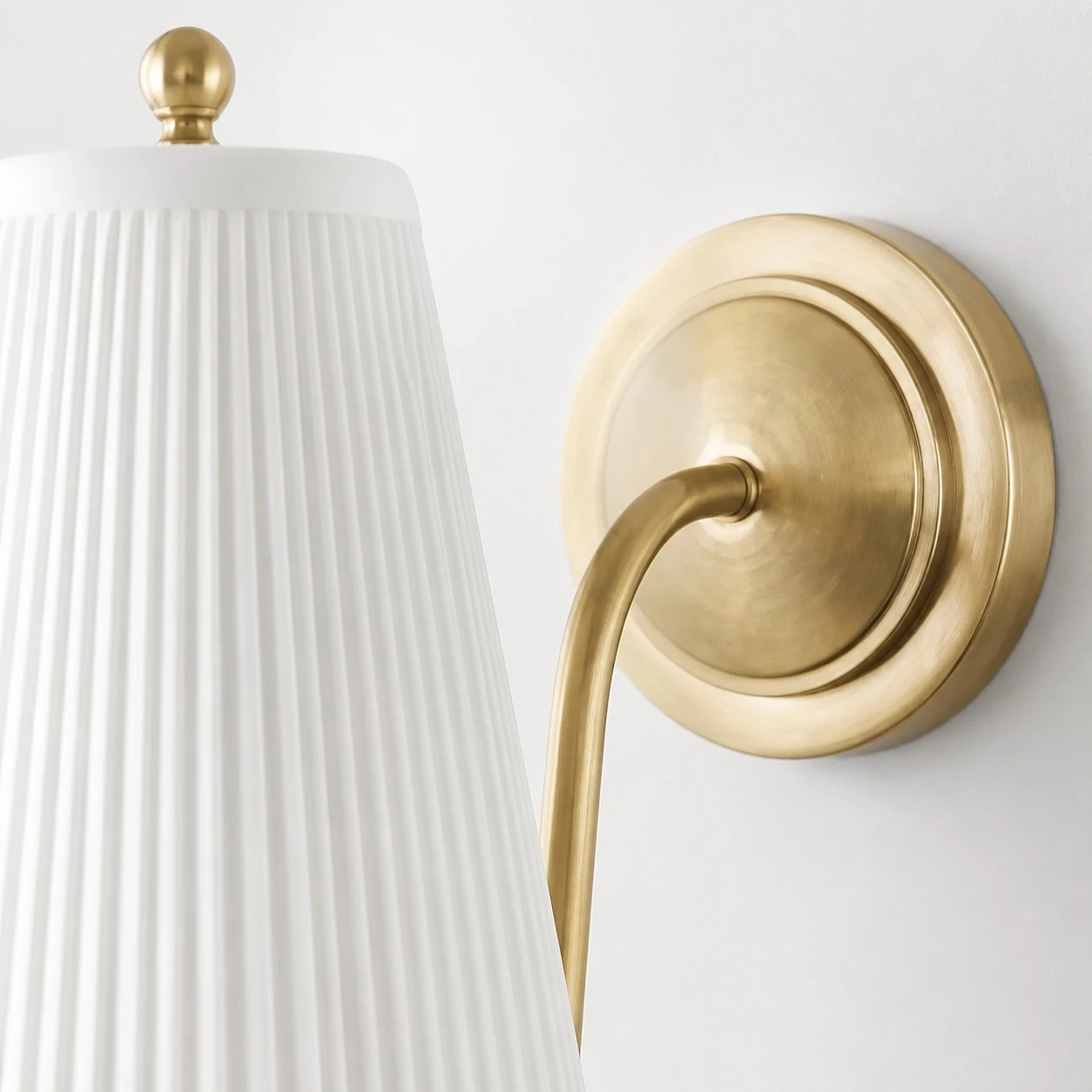 Close-up of the brass backplate and curved arm