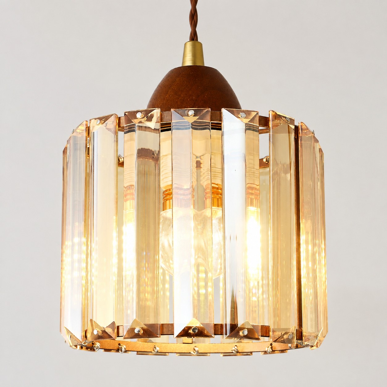 Close view of the faceted crystal shade and warm metal frame