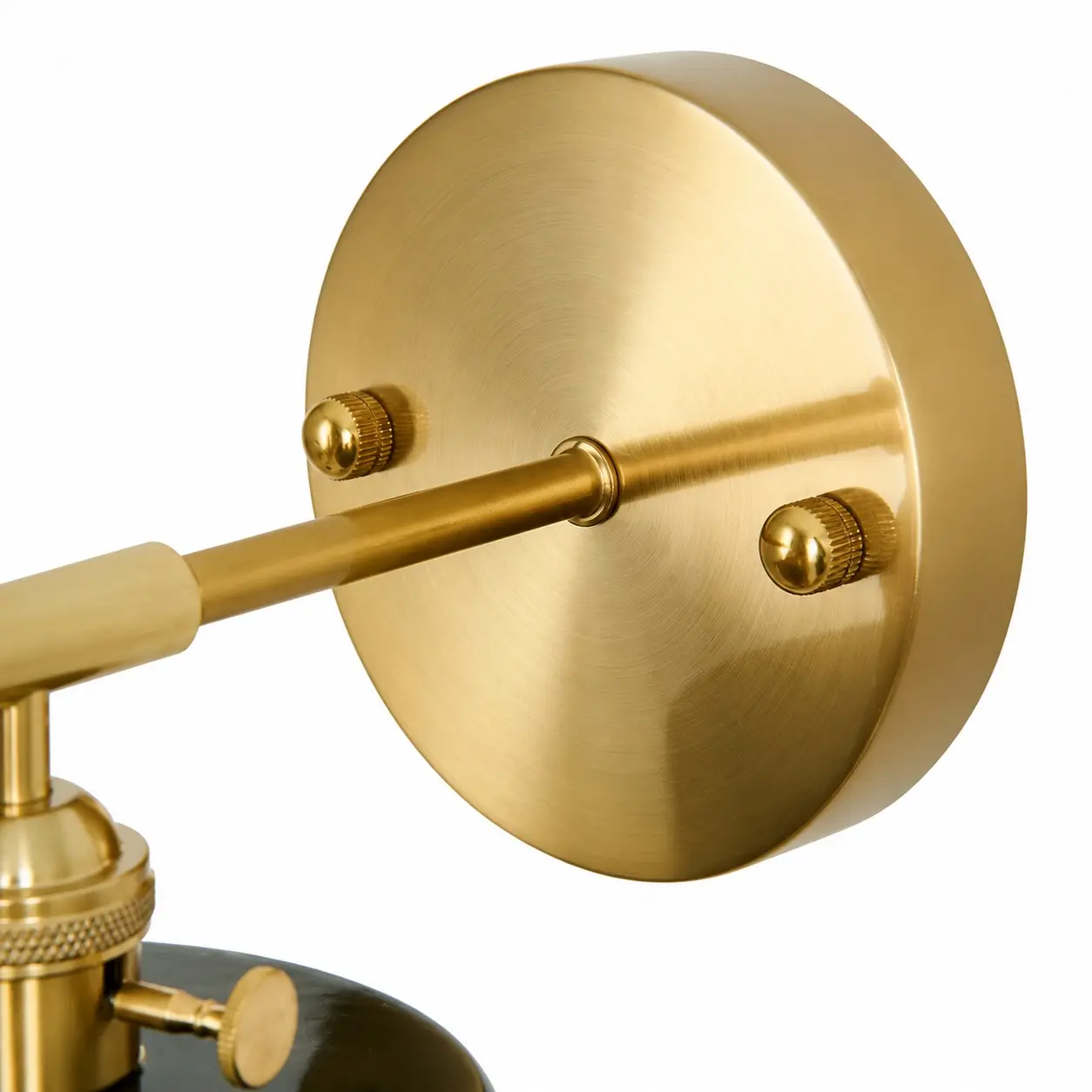 Close-up of brass wall plate and arm