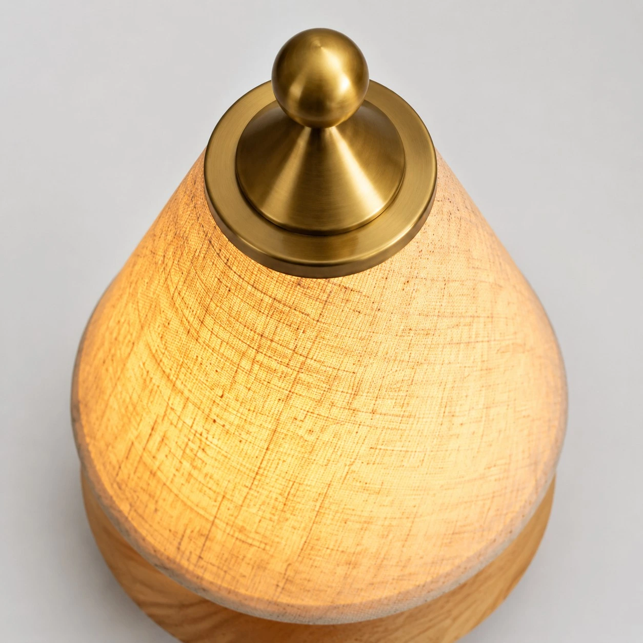 Close view of the antique brass-tone lamp finial