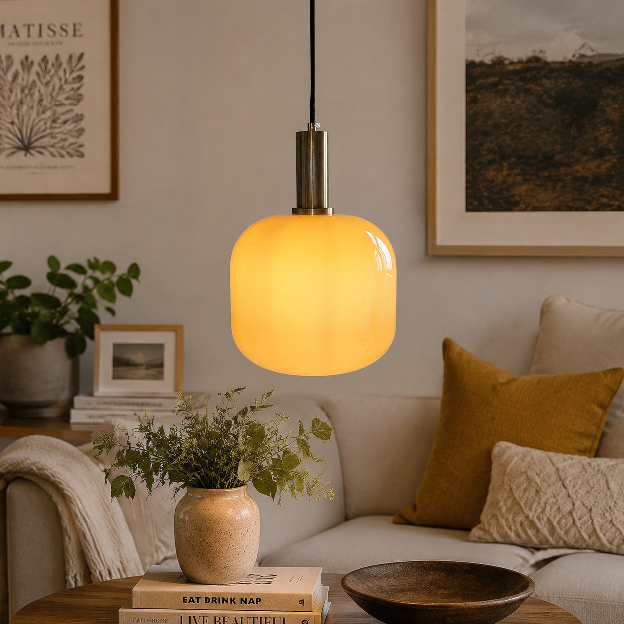 Yellow glass pendant light in a styled living room