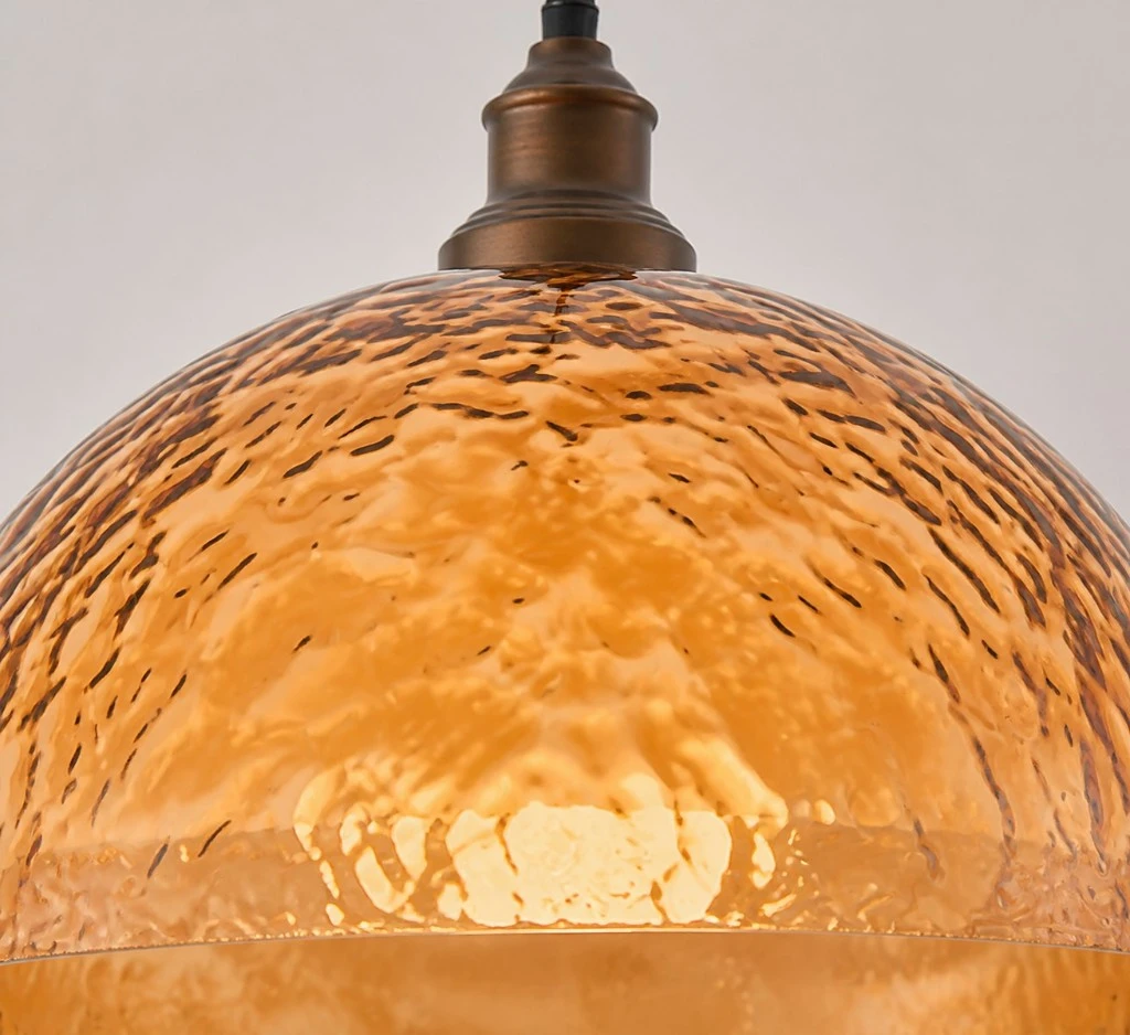 Close view of hammered amber acrylic shade texture with warm internal glow
