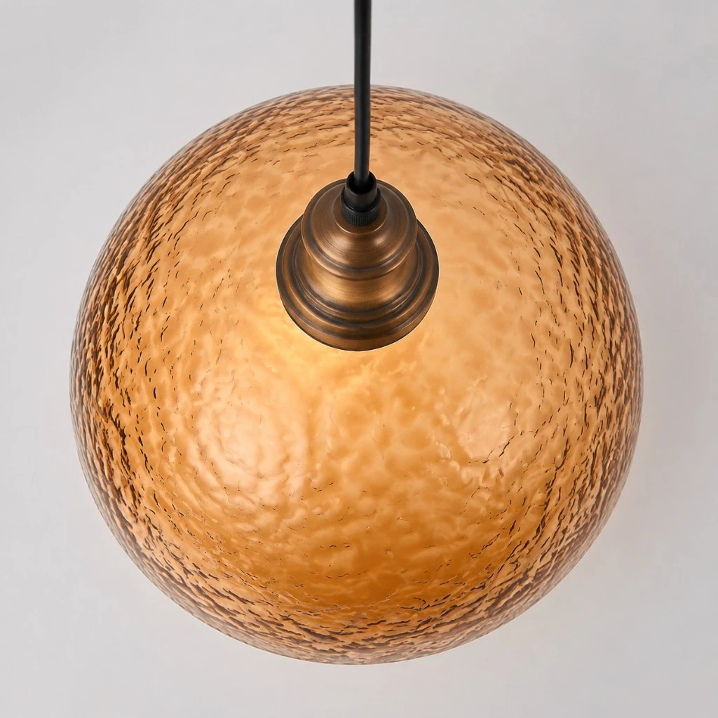Overhead view of amber textured acrylic dome and antique brass holder