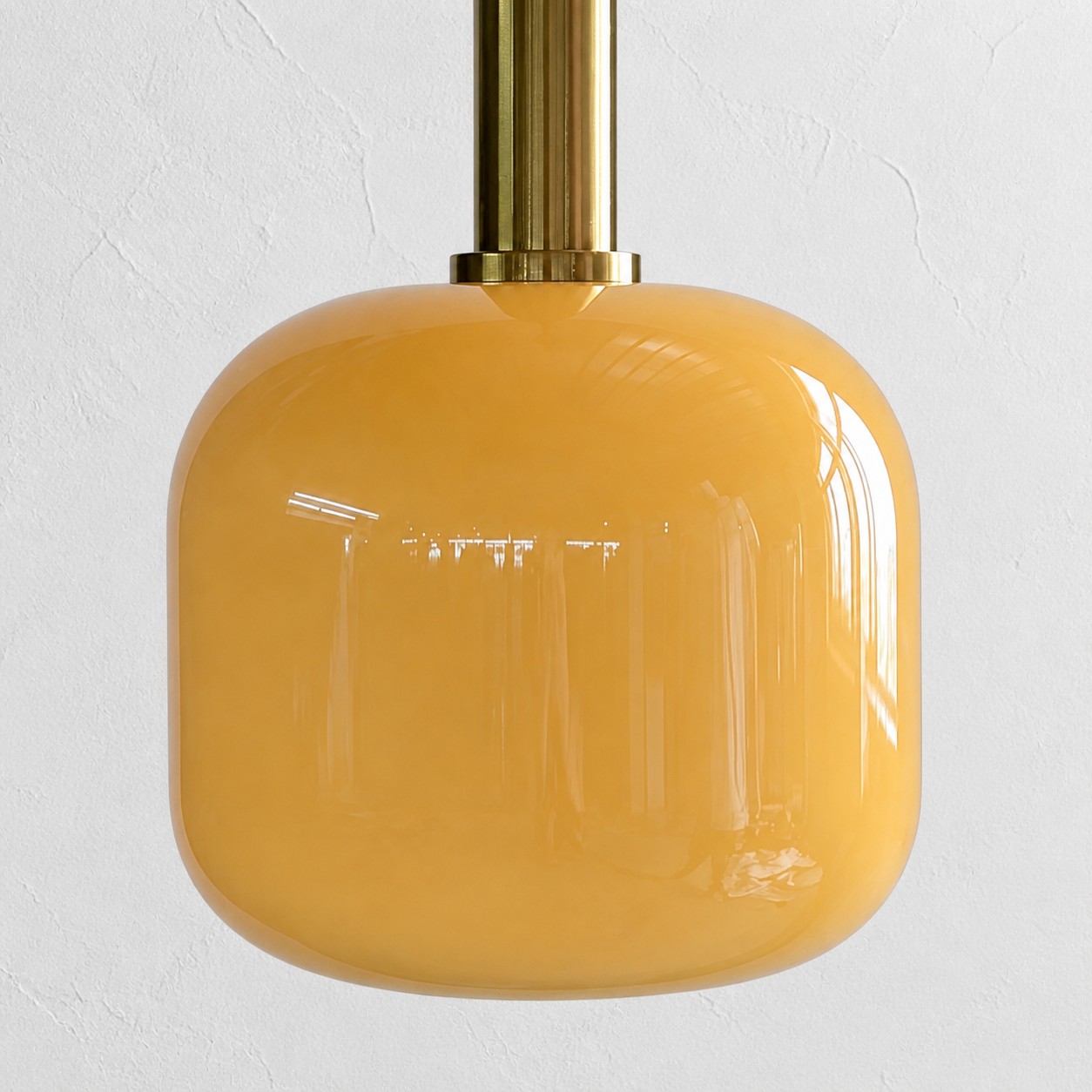Close view of the rounded glossy yellow glass shade