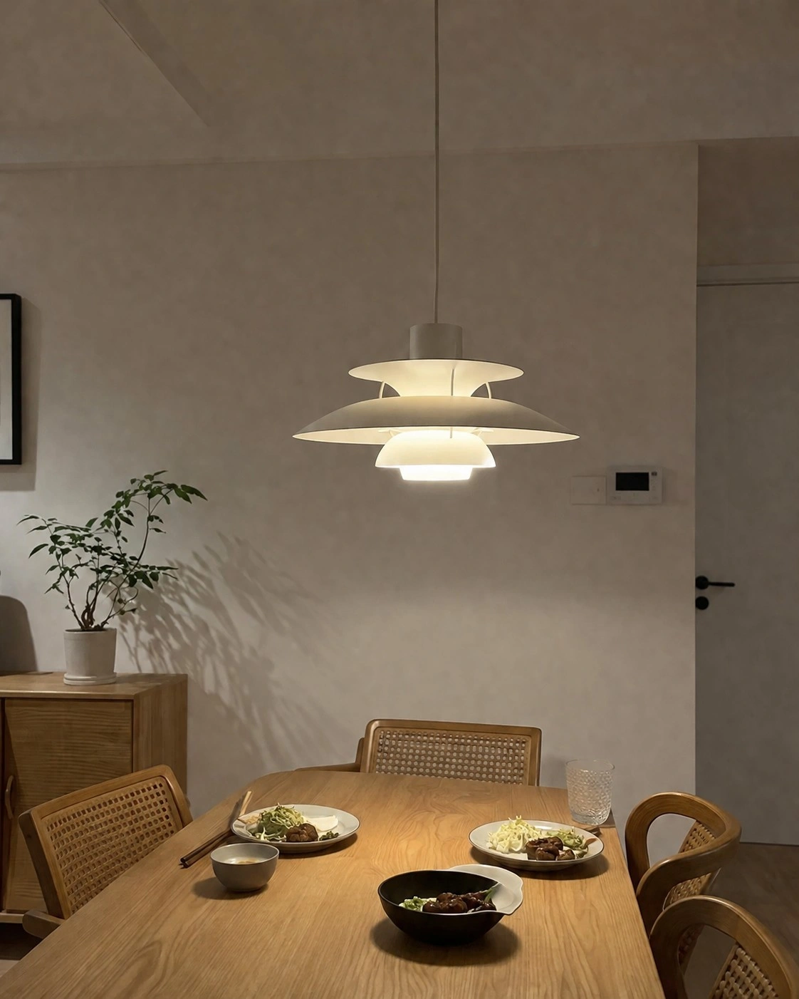 Pendant illuminated above a dining table